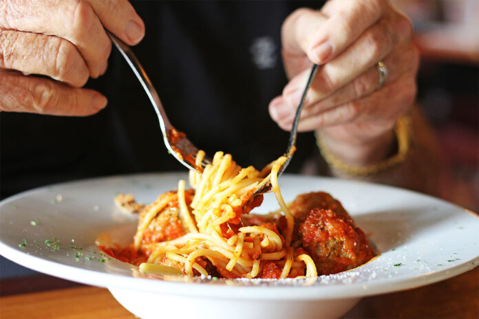 Casa D_Italia patron eating Spaghetti with Meatballs. (D.C. Thomas, Clarksville Living Magazine)