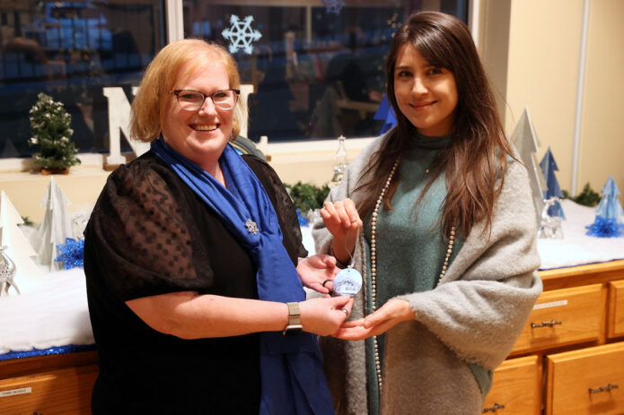 Laura Cagaoan and D.C. Thomas with the 2024 Customs House Ornament. (Mark Haynes, Clarksville Living Magazine)