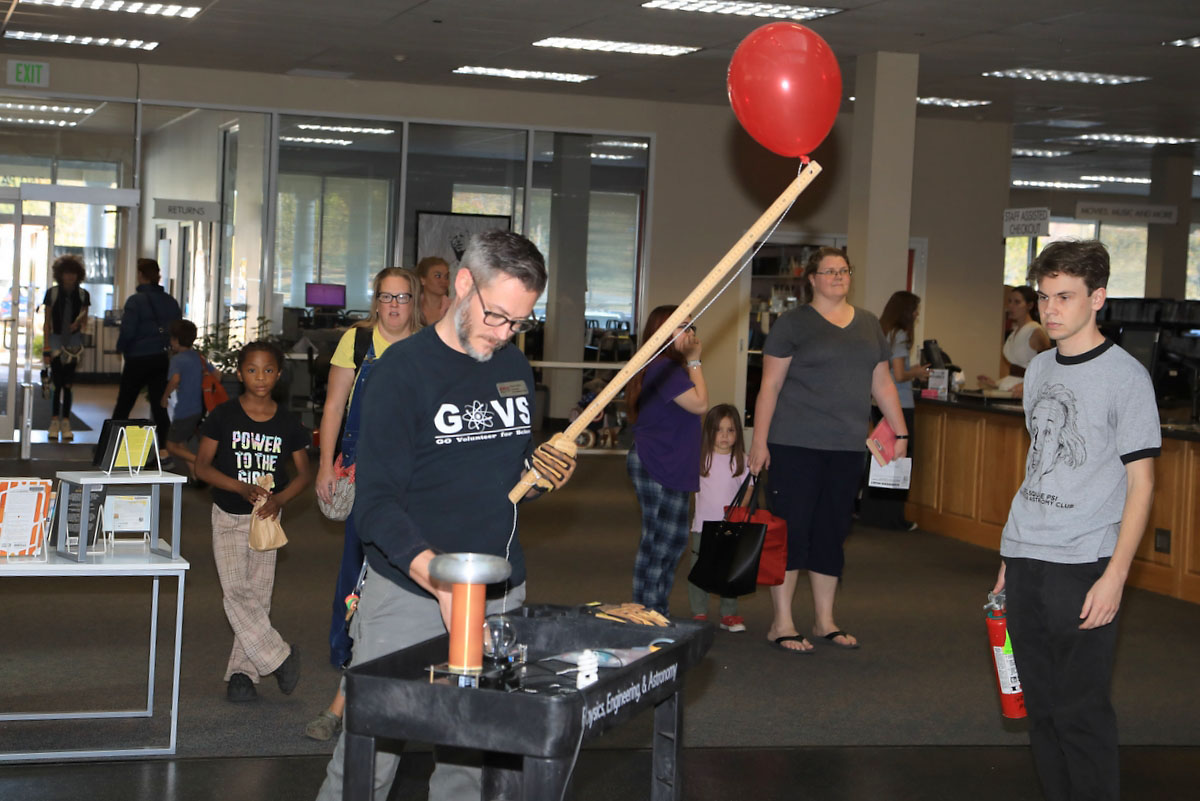 Brian Gaither demonstrating the Singing Tesla Coil, ionizing the air and igniting a hydrogen filled balloon Brian Gaither demonstrating the Singing Tesla Coil, ionizing the air and igniting a hydrogen filled balloon