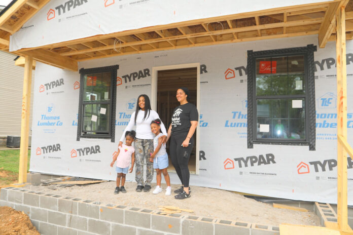 The White family with her Habitat mentor, Ericka Webster