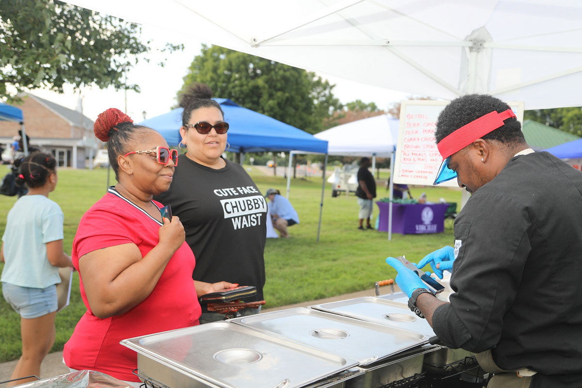 Zakiya Johnson and Christina Avila getting some Jamaican food from Omar Gooden Zakiya Johnson and Christina Avila getting some Jamaican food from Omar Gooden