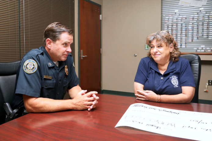 CPD Chief Ty Burdine receives a check from Montgomery County First Responders Association's Lori Mason