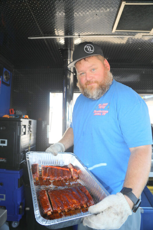 Chris Eckard of the Big James’ Kitchen team holding the ribs they entered for the inaugural BBQ Fest Across the River competition at RichEllen Park